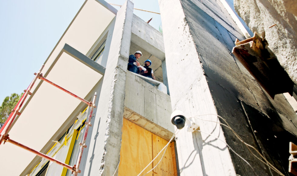 Businessmen, civil engineer and architect with blueprint for industrial development, security or co.