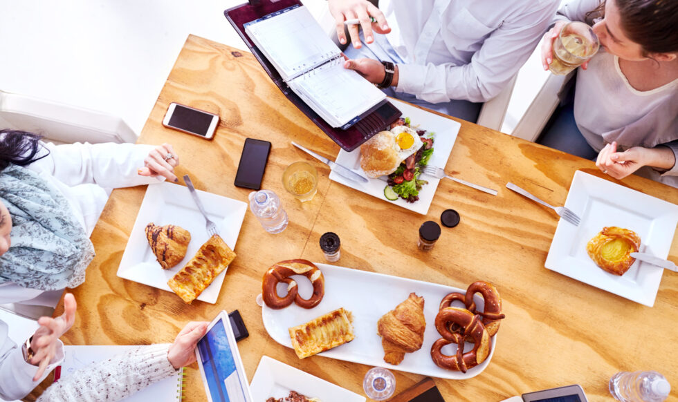 Overhead view of business team having working lunch in restaurant